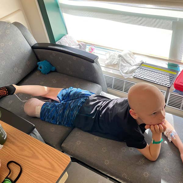 Pediatric cancer survivor Aiden watching TV